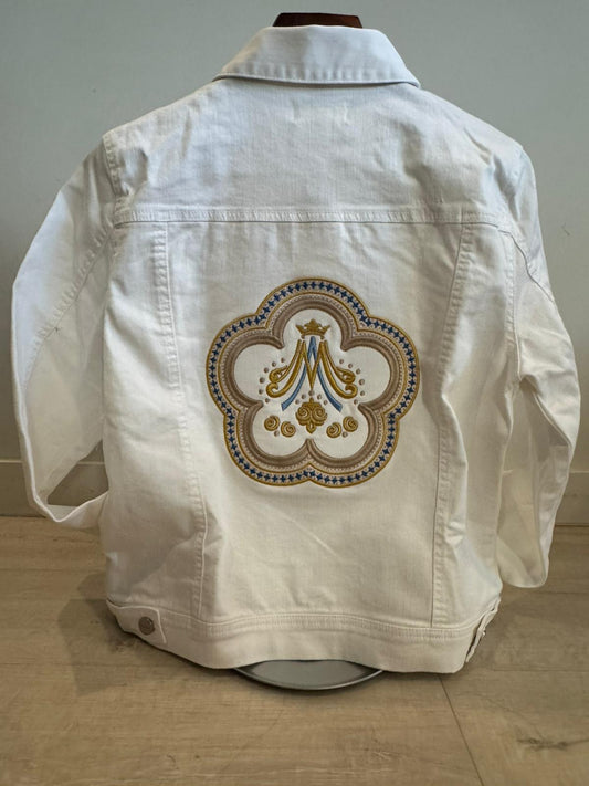White denim jacket with an embroidered design on a neutral background